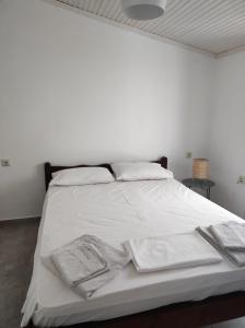 a white bed with white sheets and towels on it at ELAION GAIA in Chorto