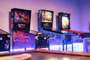 a bunch of video game consoles are lined up against a wall at 3HB Guarana - All Inclusive in Albufeira