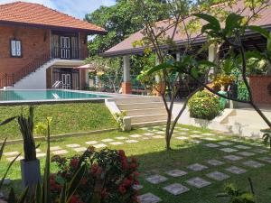 Sodas prie apgyvendinimo įstaigos Green Wood Villa Negombo