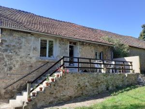 a stone house with a staircase in front of it at Le Studio du Crot Noir in Cussy-en-Morvan