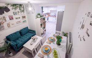a living room with a blue couch and a table at Forest Home in Northampton