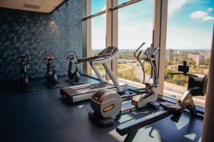 a gym with cardio machines and a large window at Van der Valk Hotel Schiedam in Schiedam