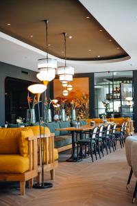 a restaurant with chairs and a table and a bar at Van der Valk Hotel Schiedam in Schiedam