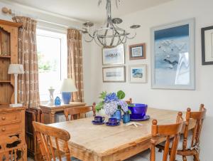 une salle à manger avec une table et des chaises en bois dans l'établissement Llwyn Gwalch, à Pwllheli 26 autres photos