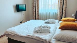 a hotel room with two beds with towels on them at Aqua Hotel in Polkowice