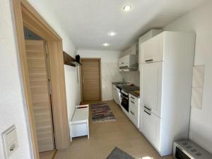 a kitchen with white appliances and a white refrigerator at Alte Mühle Börfink in Börfink