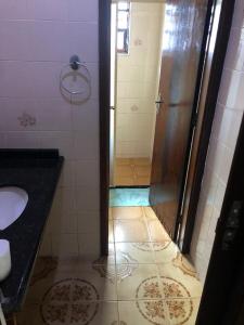 a bathroom with a shower and a sink at Pousada&Hostel Lincoln Praia Grande in Praia Grande