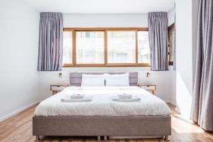 Ένα ή περισσότερα κρεβάτια σε δωμάτιο στο BreezHouse Sansa Urban Residence