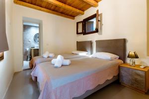 a bedroom with two beds with towels on them at Nikolas House in Xirokámbion