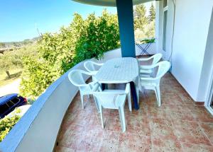 a table and chairs on the balcony of a house at Apartments Flamingo in Ulcinj