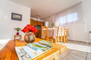 a kitchen with a table with a vase of flowers on it at Les Chalets de la Vallee du Bes in Noalhac