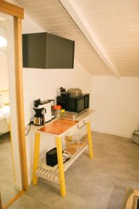 a kitchen with a table with a microwave at ENTRE PIERRE ET BOIS in Saint-Savinien