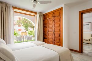 a bedroom with a bed and a large window at Parque Santiago III Official in Playa de las Americas