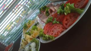 a plate of food with tomatoes and vegetables on it at Aqua Hotel in Polkowice
