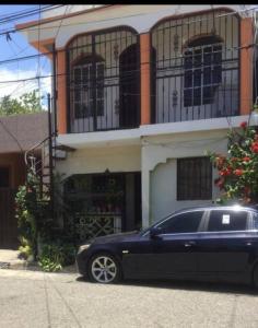 a black car parked in front of a building at Apartamento JM. in San Felipe de Puerto Plata