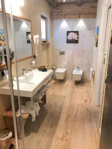 a bathroom with a sink and two toilets at Relais du Chateau Blanc in La Thuile