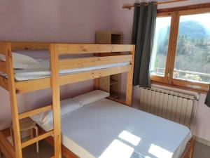2 Etagenbetten in einem Zimmer mit Fenster in der Unterkunft Alberg Can Ribals in Lles