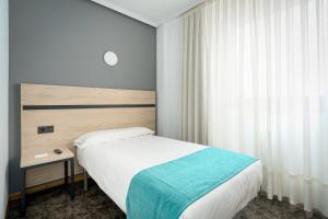 Cama o camas de una habitación en Hotel Alda Pasaje