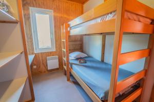 a bedroom with bunk beds in a house at Les Chalets de la Truyère in Le Malzieu-Ville