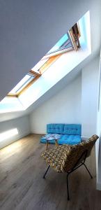 a room with a couch and skylights in a attic at Histoire de Loire La Gabare in Saumur
