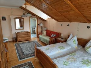 a bedroom with two beds and a living room at Haus Sundl - Privatzimmer in Emmersdorf an der Donau