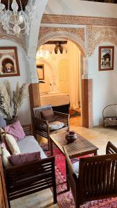 a living room with a couch and a table at Riad Catalina in Marrakech