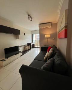 a living room with a couch and a television at Comfort Center Inn in Cordoba