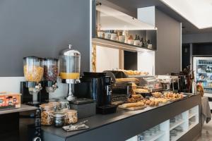 a bakery with a counter with some food on it at Hotel Travessera in Barcelona