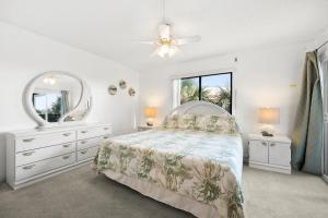 a bedroom with a bed and a dresser and a mirror at Ocean Village Club P32 in Saint Augustine