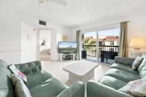 a living room with a couch and a tv at Ocean Village Club P32 in Saint Augustine