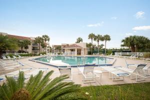 a swimming pool with lounge chairs in a resort at Ocean Village Club P32 in Saint Augustine