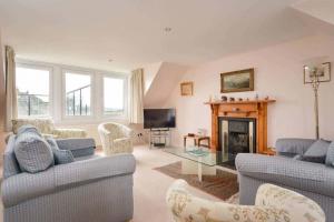 a living room with two couches and a fireplace at Links View, Golf Place in St. Andrews