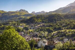 a town in a valley in the mountains at HelloChalet - Chalet Northern Lights - Family Ski Chalet with garden walking distance lift in Valtournenche