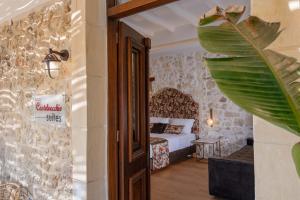 A bed or beds in a room at Castelvecchio Suites