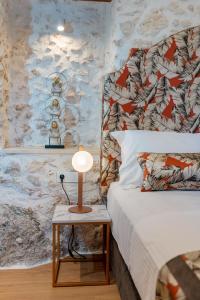 A bed or beds in a room at Castelvecchio Suites