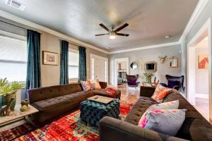 a living room with a couch and a ceiling fan at Boho Bungalow-walk to Plaza District can sleep 8 in Oklahoma City