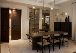 a dining room with a wooden table and chairs at The Storyteller Boutique House in Kalabaka