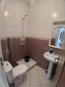a bathroom with a toilet and a sink at Families Apartment in Martil