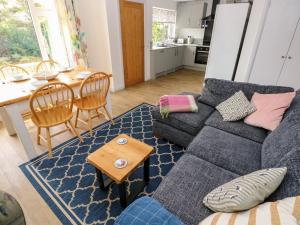 a living room with a couch and a table at Chalfonts Cottage in Haverfordwest