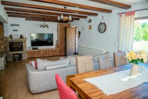 a living room with a couch and a table at House - Sleeps up to 11 hot tub & free parking in Avrig