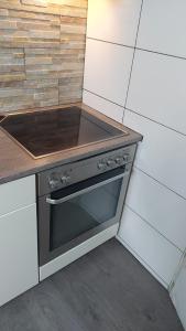 Il comprend une cuisine équipée d'une cuisinière et d'un comptoir. dans l'établissement Modernes Apartment in Minden am Hauptbahnhof, à Minden