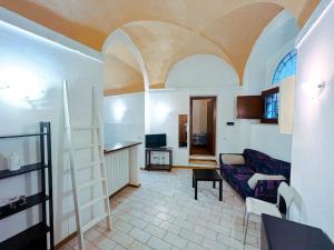 Appartamento a 2 minuti dal Centro storico في بيروجيا: غرفة معيشة بها أريكة وغرفة بها سقف