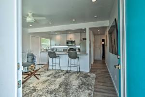 a kitchen with a counter and stools in a room at Mod San Diego Apt with Patio - Walk to Harbor! in San Diego