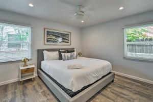 a bedroom with a large bed and two windows at Mod San Diego Apt with Patio - Walk to Harbor! in San Diego