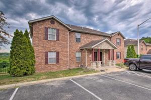 a brick house with a truck parked in a parking lot at Cozy Branson Condo with Balcony and Mountain Views in Branson