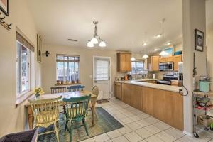 a kitchen and dining room with a table and chairs at Forested Flagstaff Getaway with Garden and Gas Grill in Mountainaire