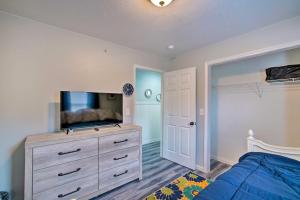 a bedroom with a bed and a dresser with a tv at Cozy Branson Condo with Balcony and Mountain Views in Branson