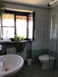 a bathroom with a tub and a toilet and a window at Cascina 'La Giardina' in Fossano