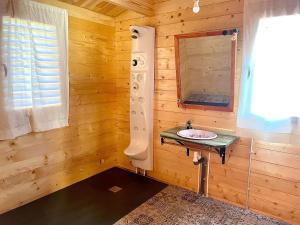 a bathroom with a sink in a wooden cabin at Dos VILLAS ENTRE CIERVOS Y CERVANTES in El Cristo del Espíritu Santo +44 photos