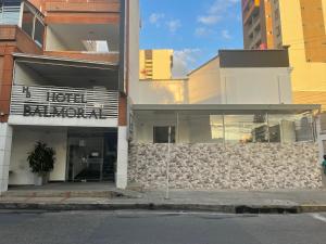 a building with a sign on the side of a street at Hotel Balmoral in Bucaramanga